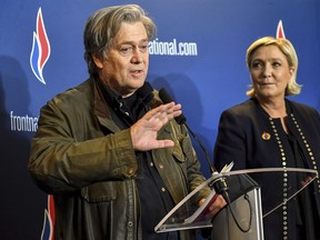 Former White House strategist Steve Bannon holds a press conference with National Front party leader Marine Le Pen, right, at the party congress in the northern French city of Lille, Saturday, March 10, 2018. Steve Bannon has given a big boost to French far right leader Marine Le Pen, telling a cheering crowd at a congress of her National Front party that "history is on our side." (AP Photo)