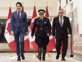 Brenda Lucki, center, Prime Minister Justin Trudeau, left, and Ralph Goodale, minister of public safety and emergency preparedness enter a press event at RCMP "Depot" Division in Regina, Saskatchewan on Friday March 9, 2018. Lucki, who was Depot's commanding officer, was appointed Canada's first permanent female RCMP commissioner.