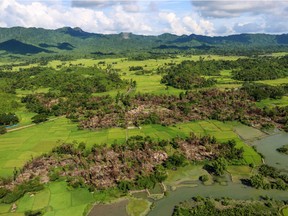 This file photo taken on October 10, 2017 shows the remains of burnt villages near Maungdaw in Northern Rakhine State.Entire villages were burned to the ground last year as Burmese forces swept through Rakhine, killing and raping in a campaign the UN human rights chief called a "textbook example of ethnic cleansing".