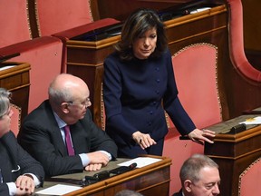 Lawmaker Maria Elisabetta Alberti Casellati, standing, attends the vote to elect the new Senate's president, in Rome, Saturday, March 24, 2018. Italian lawmakers formally reconvened parliament on Friday without any accord in sight as to the formation of a new government following inconclusive March 4 elections.
