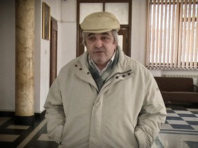 In this Wednesday, March 14, 2018 photograph Constantin Reliu speaks to media, outside a courtroom, in Vaslui, northern Romania. A Romanian court has rejected a man's claim that he's alive, after he was officially registered as deceased, according to a court spokeswoman who said that the 63-year-old man has lost his case because he appealed too late. I am a living ghost, he said venting his frustration against local authorities and his wife who he says unlawfully took ownership of a property after he was declared dead.