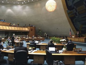 State Sen. Breene Harimoto, who is battling cancer, stands on the floor of the Hawaii Senate to voice his opposition to a medically assisted suicide bill in Honolulu on Thursday, March 29, 2018. Hawaii lawmakers have approved legislation that would make it the latest liberal-leaning state to legalize medically assisted suicide.