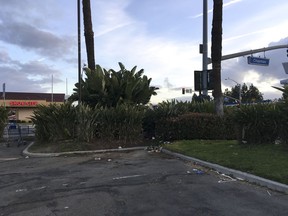 This Friday, March 16, 2018 photo shows the corner parking spot where a van containing the bodies of two adults and two children was found in Garden Grove, Calif. Police in the city near Los Angeles say a woman reported Thursday night that a white Honda was emitting a very foul odor. She told police she had seen the van parked in a drugstore lot for several days and thought its occupants were a homeless family.