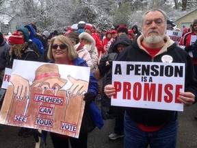 Debbie Burke, left, an elementary school teacher in Pike County, and her husband Gary Burke rally against a proposed pension overhaul bill, in Frankfort, Ky. on Wednesday, March 21, 2018.