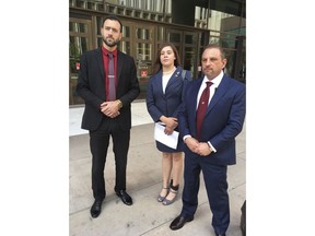 Tahnee Gonzales of Glendale, Ariz., center, stands next to her attorneys Andrew Marcantel, left, and Marc Victor, outside of the Phoenix courthouse Thursday, March 29, 2018. Gonzales pleaded not guilty to a charge of burglarizing a mosque in Tempe, Ariz. Gonzales and Elizabeth Dauenhauer, not seen, filmed themselves on March 4 as they removed fliers and Qurans from shelves, bins and bulletin boards in a fenced-in courtyard behind the Islamic Community Center in Tempe. They are known for making anti-Muslim statements at political events in the Phoenix area. Attorney Marc Victor claimed outside of court that his client's intent in going to the mosque was to make political statements.