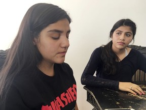 Bianca Retana, 15, left, and her sister, Miranda, 16, right, talk on Wednesday, March 21, 2018, in Albuquerque, N.M., about their teen soccer game where racial tensions erupted into a chaotic brawl on Saturday, March 17, in Bernalillo, N.M. A New Mexico youth soccer league is investigating the soccer game where parents say a parent from an opposing team ran onto the field and choked Bianca Retana from behind.