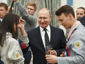 Russian President Vladimir Putin, centre, toasts with Russian Paralympians at the Kremlin in Moscow on March 20.