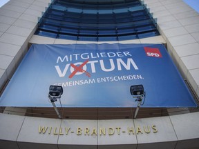 A banner is fixed at the Social democratic party's (SPD) headquarters reading: "Member Voting. Decide Together," in Berlin, Saturday, March 3, 2018.