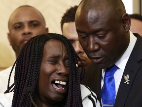 Sequita Thompson, breaks into tears as she talks about the shooting of her grandson, Stephon Clark, during a news conference, Monday, March 26, 2018, in Sacramento, Calif. Clark, who was unarmed, was shot and killed by Sacramento police officers a week ago who were responding to a call about person smashing car windows. Thompson is comforted by attorney Ben Crump, right.