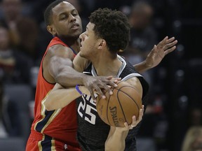 Sacramento Kings forward Justin Jackson, right, tries to keep the ball out of the reach of New Orleans Pelicans forward Darius Miller, during the first quarter of an NBA basketball game Wednesday, March 7, 2018, in Sacramento, Calif.