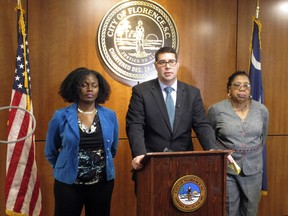 Florence, S.C., Mayor Stephen Wukela, center, talks about the shooting a a black driver by a white constable during a news conference Tuesday, March 27, 2018. He is joined by City Council members Teresa Myers Ervin, left, and Pat Gibson-Hye Moore, right. A volunteer police officer in South Carolina fired as many as eight bullets at a black driver last Saturday, who refused to get out of his vehicle during a traffic stop and appeared to be looking for something inside, a prosecutor said.