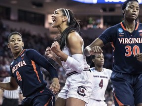 South Carolina forward A'ja Wilson, center, celebrates a basket against Virginia guard Dominique Toussaint (4) and Felicia Aiyeotan (30) during the first half of a game in the second-round of the NCAA women's college basketball tournament, Sunday, March 18, 2018, in Columbia, S.C.