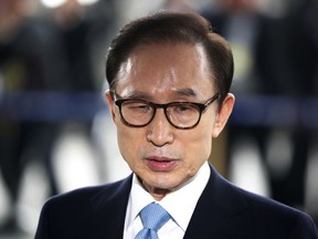FILE - In this Wednesday, March 14, 2018, file photo, former South Korean President Lee Myung-bak arrives for questioning over bribery allegations at the Seoul Central District Prosecutors' Office in Seoul, South Korea. South Korean prosecutors said on Monday, March 19, 2018, they have requested an arrest warrant for Lee over corruption allegations.