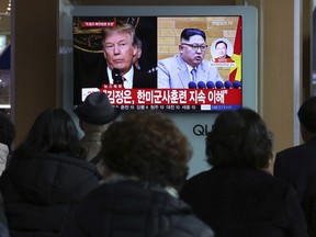 People watch a TV screen showing North Korean leader Kim Jong Un and U.S. President Donald Trump, left, at the Seoul Railway Station in Seoul, South Korea, Friday, March 9, 2018. After months of trading insults and threats of nuclear annihilation, Trump agreed to meet with North Korean leader Kim Jung Un by the end of May to negotiate an end to Pyongyang's nuclear weapons program, South Korean and U.S. officials said Thursday. No sitting American president has ever met with a North Korea leader. The signs read: " Kim Jong Un understands that the routine joint military exercises between the South Korean and the United States must continue."