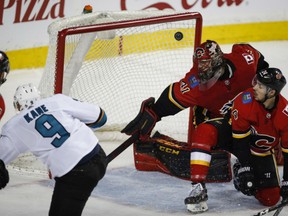 Evander Kane of the San Jose Sharks scores the third of his four goals on the night against Calgary Flames' goaltender Mike Smith during NHL action Friday at the Saddledome. Defenceman Hamonic can only watch as the puck hits the upper corner of the net. The Sharks were 7-4 winners.
