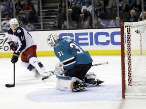 San Jose Sharks goaltender Martin Jones (31) gives up a goal on a shot from Columbus Blue Jackets' Nick Foligno as the Blue Jackets' Matt Calvert (11) looks on during the first period of an NHL hockey game, Sunday, March 4, 2018, in San Jose, Calif.