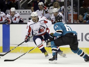 Washington Capitals' Alex Ovechkin, left, controls the puck in front of San Jose Sharks' Justin Braun during the second period of an NHL hockey game Saturday, March 10, 2018, in San Jose, Calif.