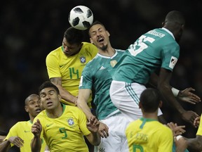 Germany's Sandro Wagner, center, is airborne with Brazil's Thiago Silva during the international friendly soccer match between Germany and Brazil in Berlin, Germany, Tuesday, March 27, 2018.
