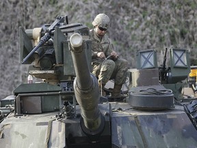 A U.S. Army soldier works on a M1A2 tank during a military exercise in Paju, near the border with North Korea, South Korea, Friday, April 21, 2017.