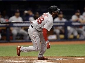 Boston Red Sox's Eduardo Nunez follows the flight of his two-run, inside-the-park home run off Tampa Bay Rays starting pitcher Chris Archer during the second inning of a baseball game Thursday, March 29, 2018, in St. Petersburg, Fla.