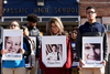 Students from Passaic High School hold photos of some of the 17 victims killed at Marjory Stoneman Douglas High School as they participate in a walkout to protest gun violence, Wednesday, March 14, 2018, in Passaic, N.J.