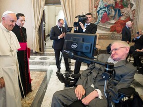 FILE - In this Monday, Nov. 28, 2016 file photo Pope Francis greets physicist Stephen Hawking during an audience with participants at a plenary session of the Pontifical Academy of Sciences, at the Vatican. Hawking, whose brilliant mind ranged across time and space though his body was paralyzed by disease, has died, a family spokesman said early Wednesday, March 14, 2018.