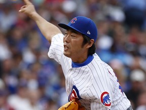 FILE - In this Sept. 2, 2017, file photo, Chicago Cubs' Koji Uehara pitches against the Atlanta Braves during the seventh inning of a baseball game in Chicago. Former major league pitcher Uehara has returned to his former Japanese team the Yomiuri Giants. The Central League team announced on Friday, March 9, 2018 that they signed Uehara but financial terms of the deal were not revealed.