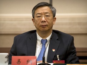 FILE - In this Oct. 19, 2017, file photo, Yi Gang, deputy governor of the People's Bank of China, attends a discussion group meeting held on the sidelines of China's 19th Party Congress at the Great Hall of the People in Beijing. The ceremonial Chinese legislature on Monday, March 19, 2018, approved the appointment of Yi Gang, a veteran deputy central banker, to lead the People's Bank of China.