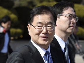 South Korea's national security director Chung Eui-yong, front, walks to board an aircraft as he leaves for Pyongyang at a military airport in Seongnam, south of Seoul, Monday, March 5, 2018. A group of high-level South Korean officials has left for North Korea for talks on North Korea's nuclear program and ways to help resume talks between Pyongyang and Washington.