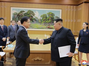 In this Monday, March 5, 2018 photo, provided by the North Korean government on March 6, North Korean leader Kim Jong Un, front right, shakes hands with South Korean National Security Director Chung Eui-yong after Chung gave Kim the letter from South Korean President Moon Jae-in, in Pyongyang, North Korea. Independent journalists were not given access to cover the event depicted in this image distributed by the North Korean government. The content of this image is as provided and cannot be independently verified. Korean language watermark on image as provided by source reads: "KCNA" which is the abbreviation for Korean Central News Agency. (Korean Central News Agency/Korea News Service via AP)
