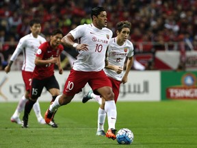 In this Oct. 18, 2017 photo, Shanghai SIPG's Hulk, center, controls the ball, with Oscar, right, both of Brazil in the second leg of their Asian Champions League soccer semifinal against Urawa Reds in Saitama. The spending may have slowed but world-famous coaches such as Fabio Capello and Manuel Pellegrini and players like Hulk and Javier Mascherano still have the same objective in the 2018 Chinese Super League that kicks off on Friday: to stop Guangzhou Evergande from winning an eighth consecutive title.