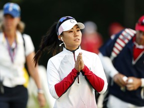 FILE - In this Aug. 18, 2017 file photo, Danielle Kang of the United States, walks to the practice green before her foursome match in the Solheim Cup golf tournament, in West Des Moines, Iowa.  Danielle Kang recovered from a bizarre mishap that left her nursing a broken tooth to charge up the leaderboard on the opening day of the LPGA Singapore tournament on Thursday, March 1, 2018. The reigning Women's PGA Championship title holder, Kang said she fell asleep while exercising ahead of her opening round, and woke up feeling pain in her mouth.