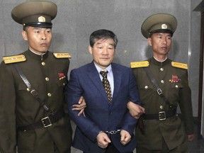 FILE - In this April 29, 2016, file photo, Kim Dong Chul, center, a U.S. citizen detained in North Korea, is escorted to his trialin Pyongyang, North Korea. He was sentenced in April 2016 to 10 years in prison with hard labor after being convicted of espionage. The announcement of a possible U.S.-North Korea summit is raising hope that Kim Jong Un will release 3 American citizens, including Kim Dong Chul, now imprisoned in the North.