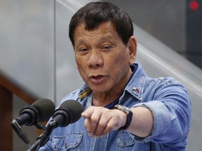 FILE - In this Feb. 13, 2018, file photo, Philippine President Rodrigo Duterte addresses Filipino Overseas Workers who were repatriated from Kuwait at the Ninoy Aquino International Airport in suburban Pasay city, southeast of Manila, Philippines. Duterte asked other countries on Sunday, March 18, 2018 to abandon the International Criminal Court because it is "rude." Duterte is facing a possible complaint before the world tribunal for the thousands of killings of drug suspects during his time in office.