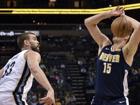 Memphis Grizzlies center Marc Gasol (33) knocks the ball away from Denver Nuggets center Nikola Jokic (15) during the first half of an NBA basketball game Saturday, March 17, 2018, in Memphis, Tenn.