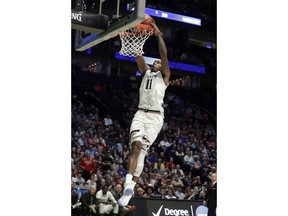 Cincinnati forward Gary Clark (11) slam dunks in the second half of a first-round game against Georgia State in the NCAA college basketball tournament in Nashville, Tenn., Friday, March 16, 2018.