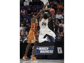 Nevada guard Jordan Caroline (24) shoots against Texas forward Mohamed Bamba in the second half of a first-round game of the NCAA college basketball tournament in Nashville, Tenn., Friday, March 16, 2018.