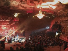 In this Feb. 25, 2018 photo, music fans fill much of the expansive Volcano Room beneath an antique, 1,500-pound chandelier that once hung in the Loew's Metropolitan Theatre in New York City. in McMinnville, Tenn. More than 500 music fans had found their way 333 feet below the ground, some taller guests ducking their heads just a bit.
