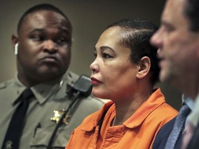 FILE - In this Feb. 26, 2018, file photo, Sherra Wright, center, appears in court with attorney Steve Farese Jr., right, in Memphis, Tenn. The ex-wife of former NBA player Lorenzen Wright won't face the death penalty if convicted of killing him more than seven years ago in Tennessee, a prosecutor said Monday, March 19, 2018. Shelby County prosecutor Paul Hagerman told a judge during a hearing that Sherra Wright won't face a death sentence if found guilty of first degree murder in her ex-husband's shooting death. She is being held without bond and has pleaded not guilty in one of the most high-profile murder cases in Memphis' history.
