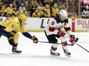 New Jersey Devils left wing Taylor Hall (9) tries to get past Nashville Predators' Ryan Johansen (92) in the first period of an NHL hockey game Saturday, March 10, 2018, in Nashville, Tenn.