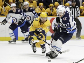 Winnipeg Jets left wing Nikolaj Ehlers (27), of Denmark, moves the puck against Nashville Predators right wing Ryan Hartman (38) in the first period of an NHL hockey game Tuesday, March 13, 2018, in Nashville, Tenn.