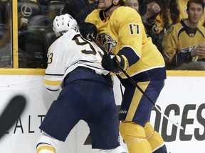 Nashville Predators left wing Scott Hartnell (17) checks Buffalo Sabres defenseman Victor Antipin (93), of Kazakhstan, into the boards in the second period of an NHL hockey game Saturday, March 31, 2018, in Nashville, Tenn. Antipin was taken off the ice on a stretcher. Hartnell was given a game misconduct penalty for boarding.