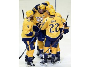 Nashville Predators defenseman Roman Josi (59), of Switzerland, celebrates with teammates after scoring a goal against the Minnesota Wild during the first period of an NHL hockey game Tuesday, March 27, 2018, in Nashville, Tenn.
