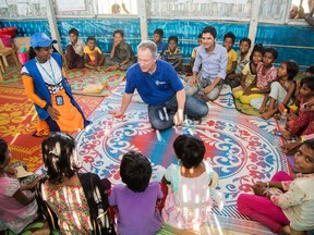 In this photo provided by the World Food Program, World Food Program executive director David Beasley talks to children at a refugee center at Cox's Bazar in Bangladesh in early October, 2017.  Beasley says the collapse of the Islamic State movement's self-described caliphate across Syria and Iraq has led to extremists mounting a recruitment drive in sub-Sahara Africa which threatens to trigger a new European migrant crisis.