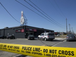 Toronto Police Services investigate the scene where two people were gunned down outside a north-end bowling alley.  Toronto police say a woman, an innocent bystander,  died in hospital after multiple shots were fired on Saturday night that also left a man dead. Police say the man was apparently the target as investigators search for 3 suspects in Toronto's 13th & 14th homicide of 2018.