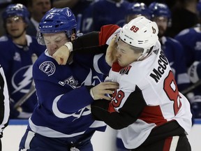 Ottawa Senators left wing Max McCormick (89) connects with a punch as he fights Tampa Bay Lightning left wing Adam Erne (73) during the first period of an NHL hockey game Tuesday, March 13, 2018, in Tampa, Fla.