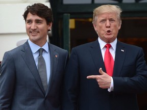 U.S. President Donald Trump points to Prime Minister Justin Trudeau as he welcomes him to the White House in Washington, D.C.
