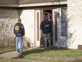 Authorities are investigating the scene in East Austin, Texas, after a teenager was killed and a woman was injured in the second Austin package explosion in the past two weeks Monday, March 12, 2018. Authorities say a package that exploded inside of an Austin home on Monday is believed to be linked to a deadly package sent to another home in Texas' capital city earlier this month.