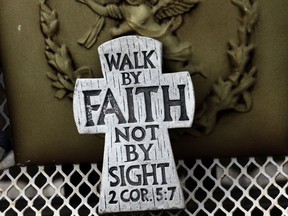 In this Feb. 7, 2018, photo, a cross rests on a bench on the front porch of Leandra Mulla's home in Tabor City, N.C. As a high school freshman in 2014, Mulla told Army investigators her ex-boyfriend dragged her to a secluded area of their base in Germany and sexually assaulted her. Four years later, she still wonders what came of her report.