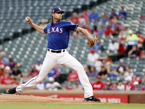 Texas Rangers starting pitcher Doug Fister throws during the first inning of a spring training baseball game against the Cincinnati Reds, Monday, March 26, 2018, in Arlington, Texas.